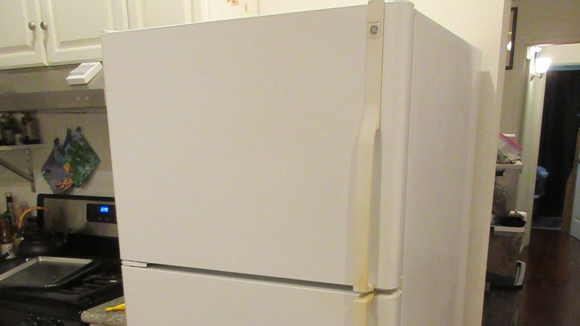 Domestic refrigerator in home kitchen. GE brand, used.