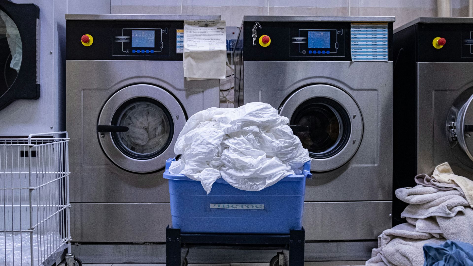 a laundry room with a washing machine and a laundry basket