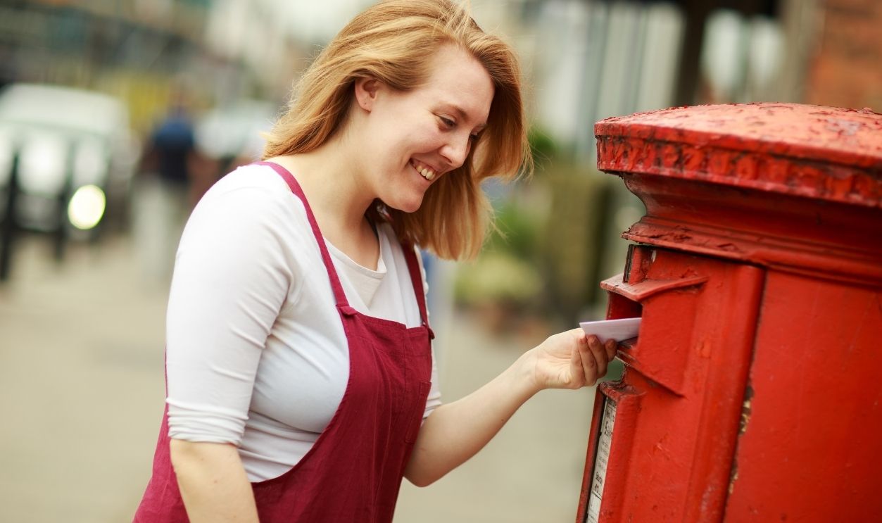 young woman posting a letter