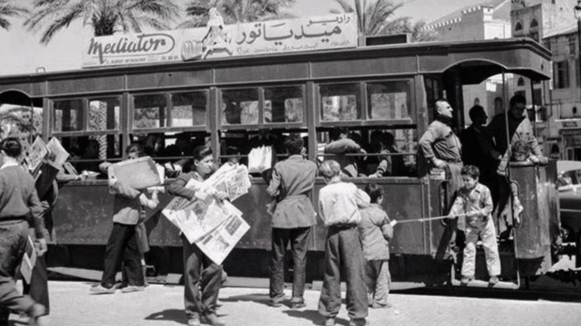 Children selling newspapers near the tramway, Beirut - February 04, 1956