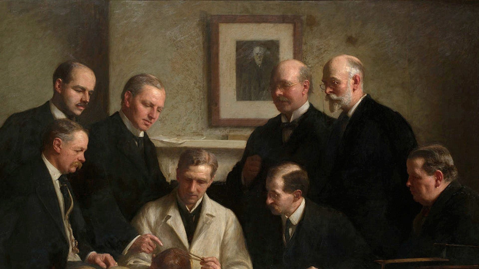 The portrait painted by John Cooke in 1915. Back row: (left to right) F. O. Barlow, G. Elliot Smith, Charles Dawson, Arthur Smith Woodward. Front row: A. S. Underwood, Arthur Keith, W. P. Pycraft, and Sir Ray Lankester. Note the painting of Charles Darwin