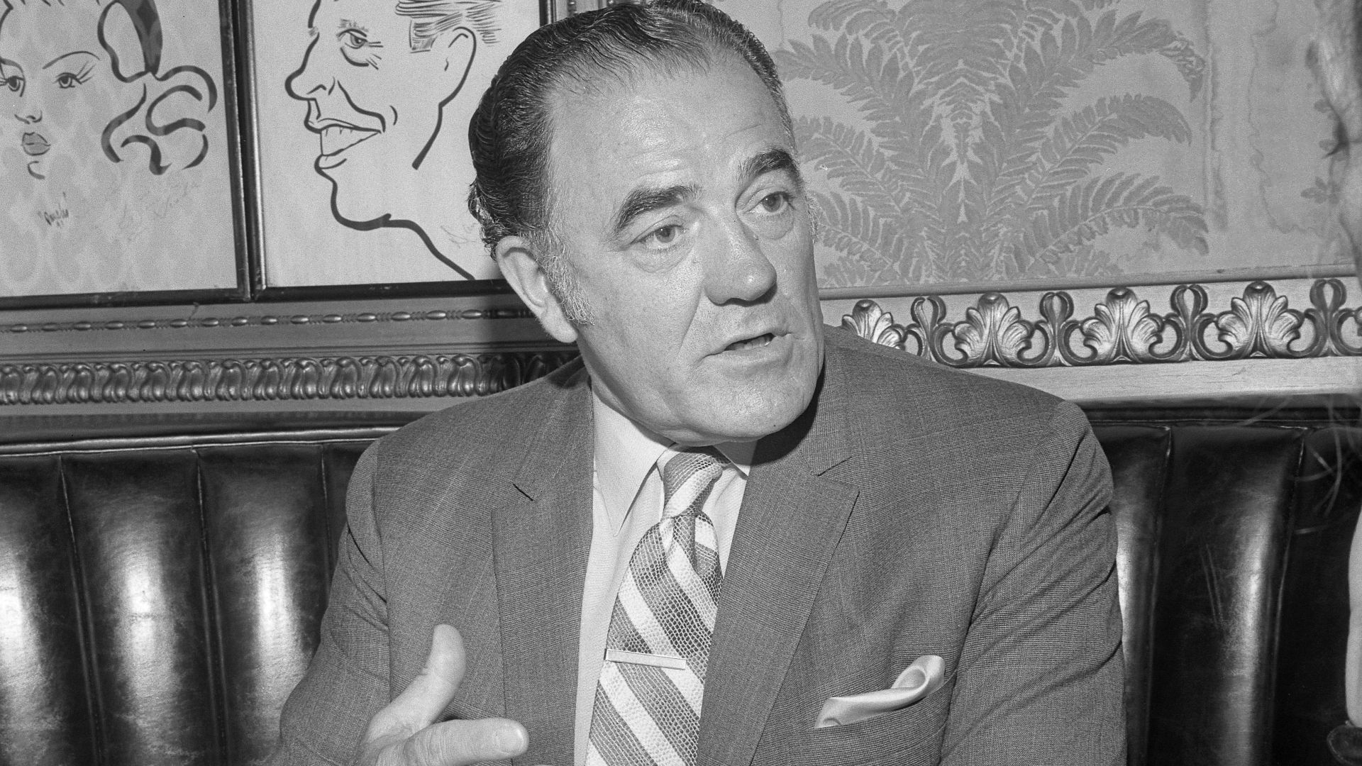 Author Louis L'Amour seated at restaurant table during interview in Los Angeles