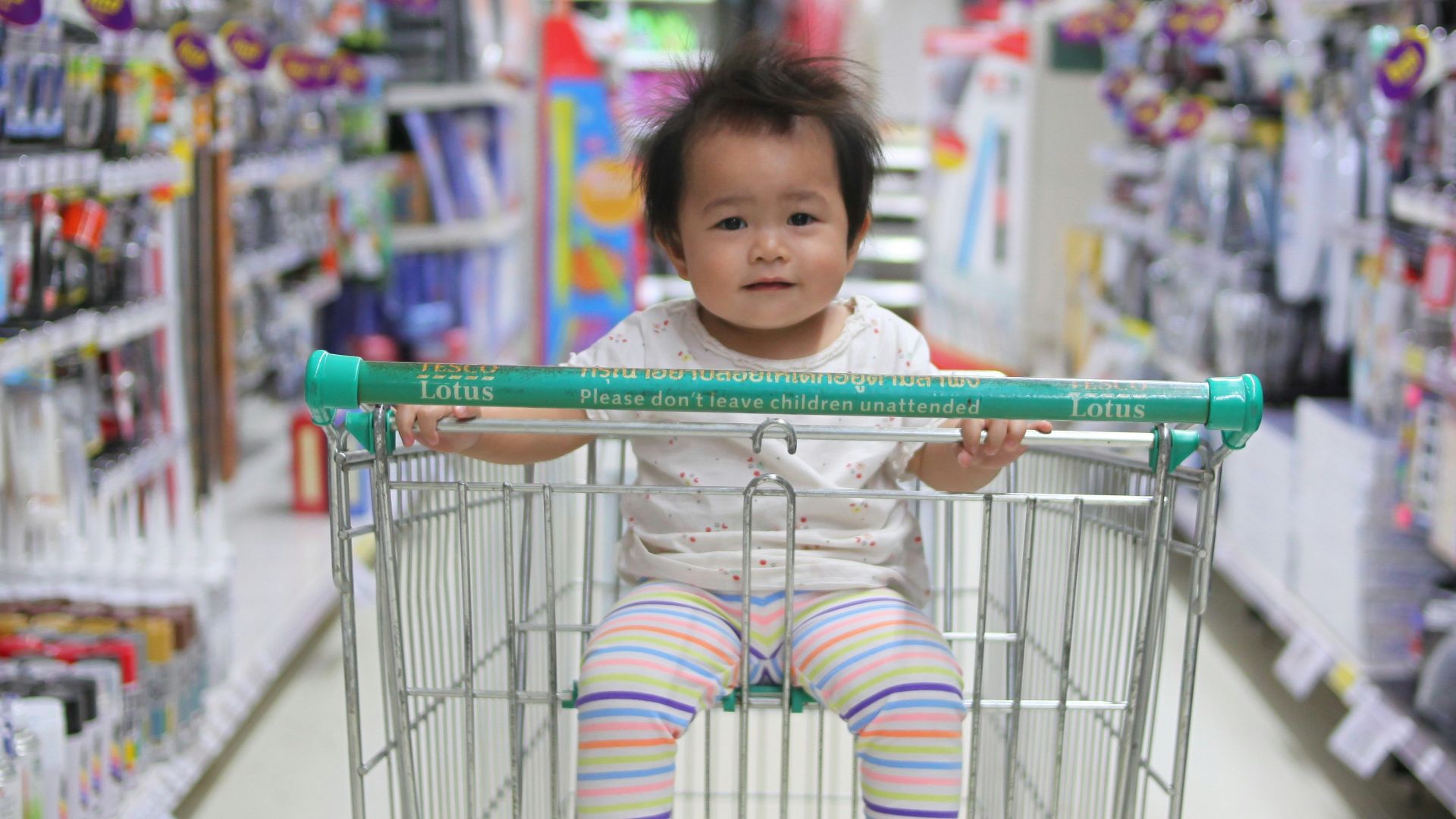 baby on white shopping cart