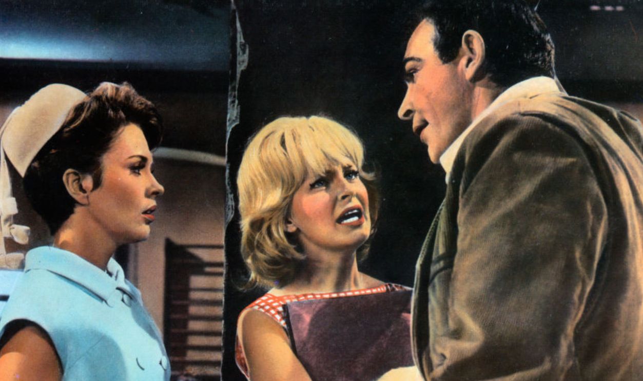 Jean Seberg and Joanne Woodward talk to Patrick O'Neal in a scene from the film 'A Fine Madness', 1966.