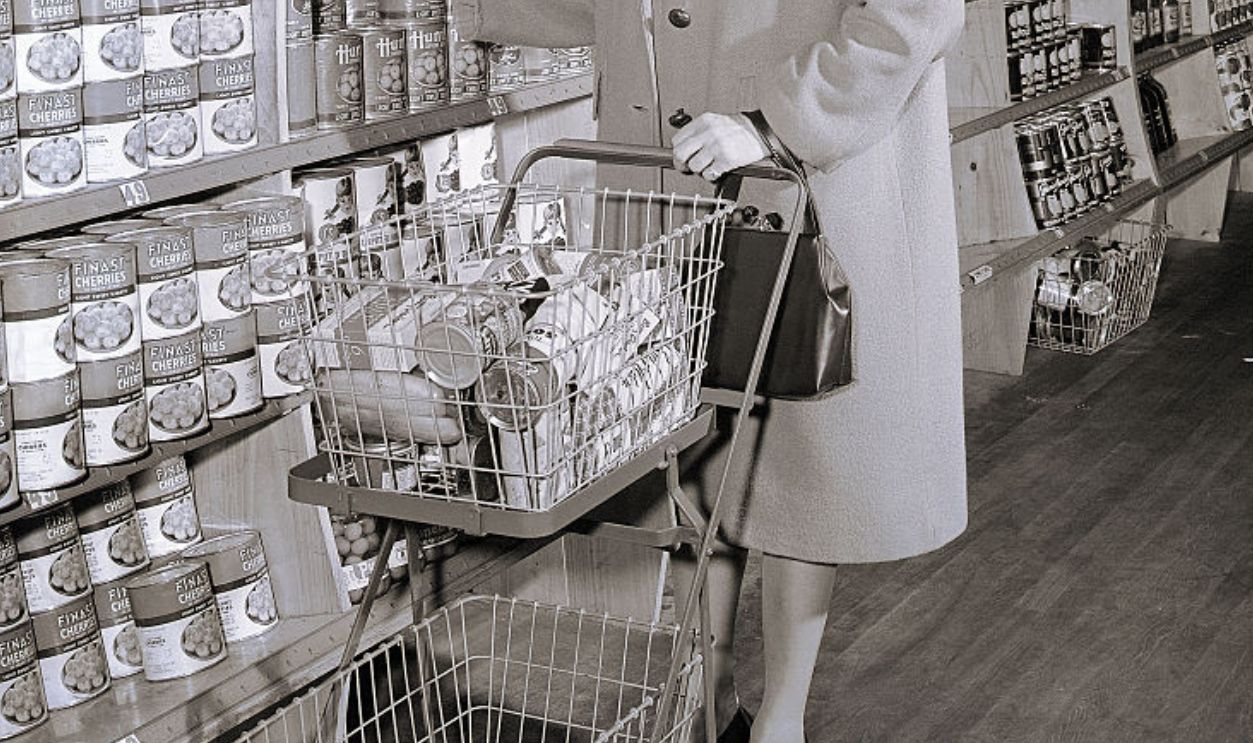 (Original Caption) Photo shows a woman buying food in a self-service grocery store. Model: Ruth McGovern. Ca. 1940s-1950s.