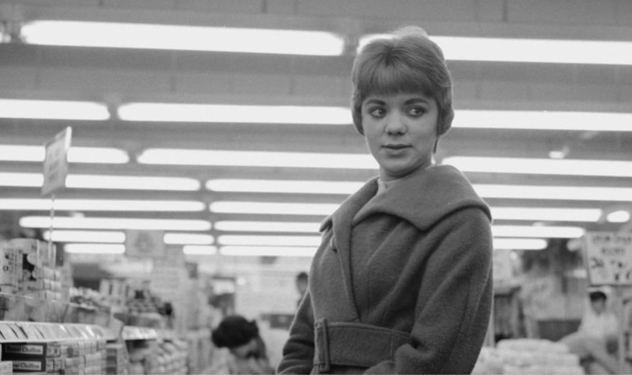 A woman holding a shopping basket in a Tesco supermarket in Hatfield, Hertfordshire, on November 16th, 1959. 