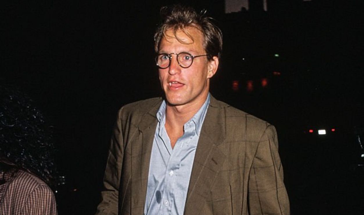 American actor Woody Harrelson wearing a brown suit jacket over a blue shirt, circa 1990.