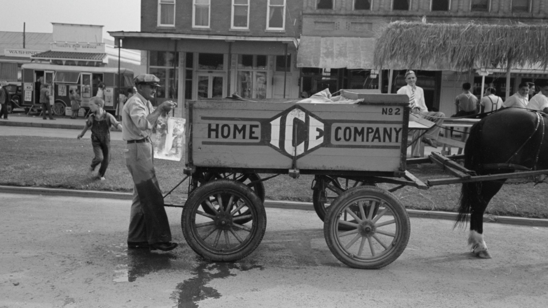 Delivering ice to stands, National Rice Festival, Crowley Louisiana, 1938. Shows iceman holding block of ice in tongs behind horse drawn ice wagon.