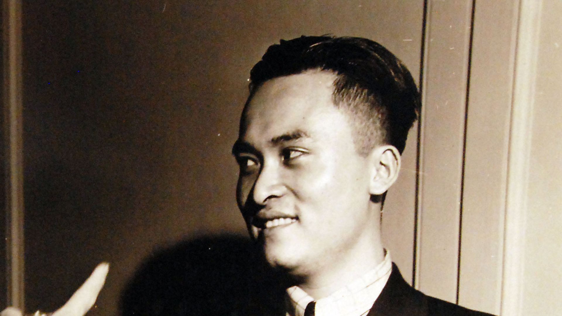 80-G-42356:  Poon Lim, a 25-year-old Chinese mess steward, shows Rear Admiral Julius Furer how he took the spring out of an electric light and made a fish hook while he was adrift in the South Atlantic for 133 days.  When his ship was torpedoed off the co