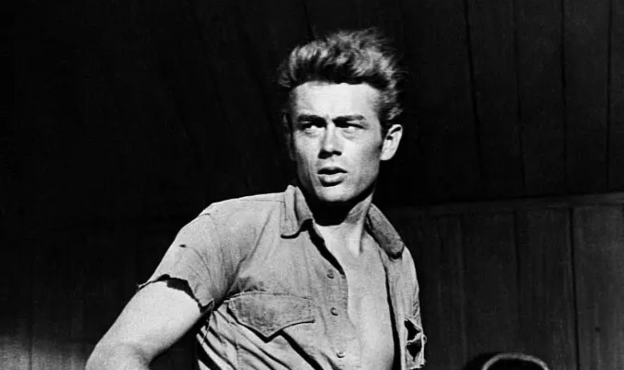 (Original Caption) James Dean in scenes from his last movie Giant. James Dean standing in 3/4 photo.