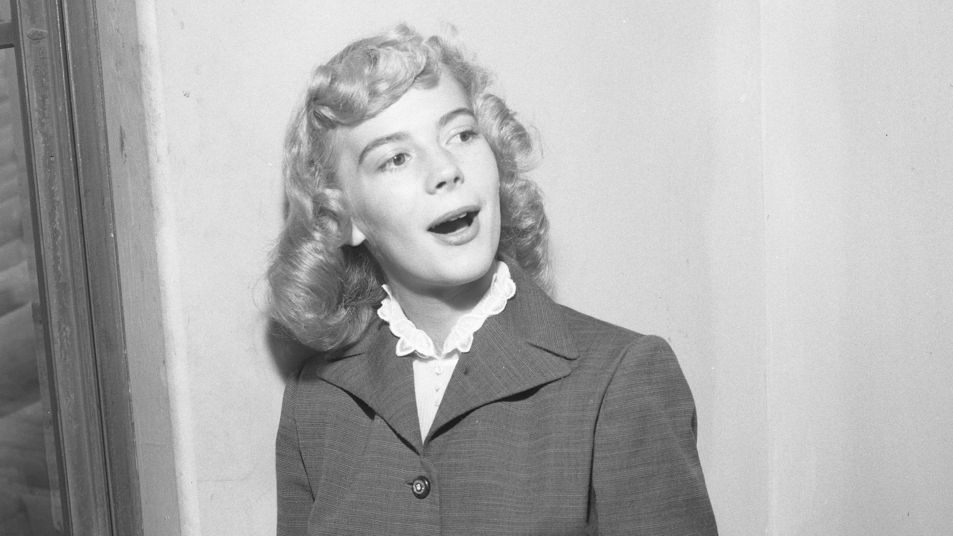 Actress Natalie Wood with blond hair at age 16 reviewing contract approval in Los Angeles