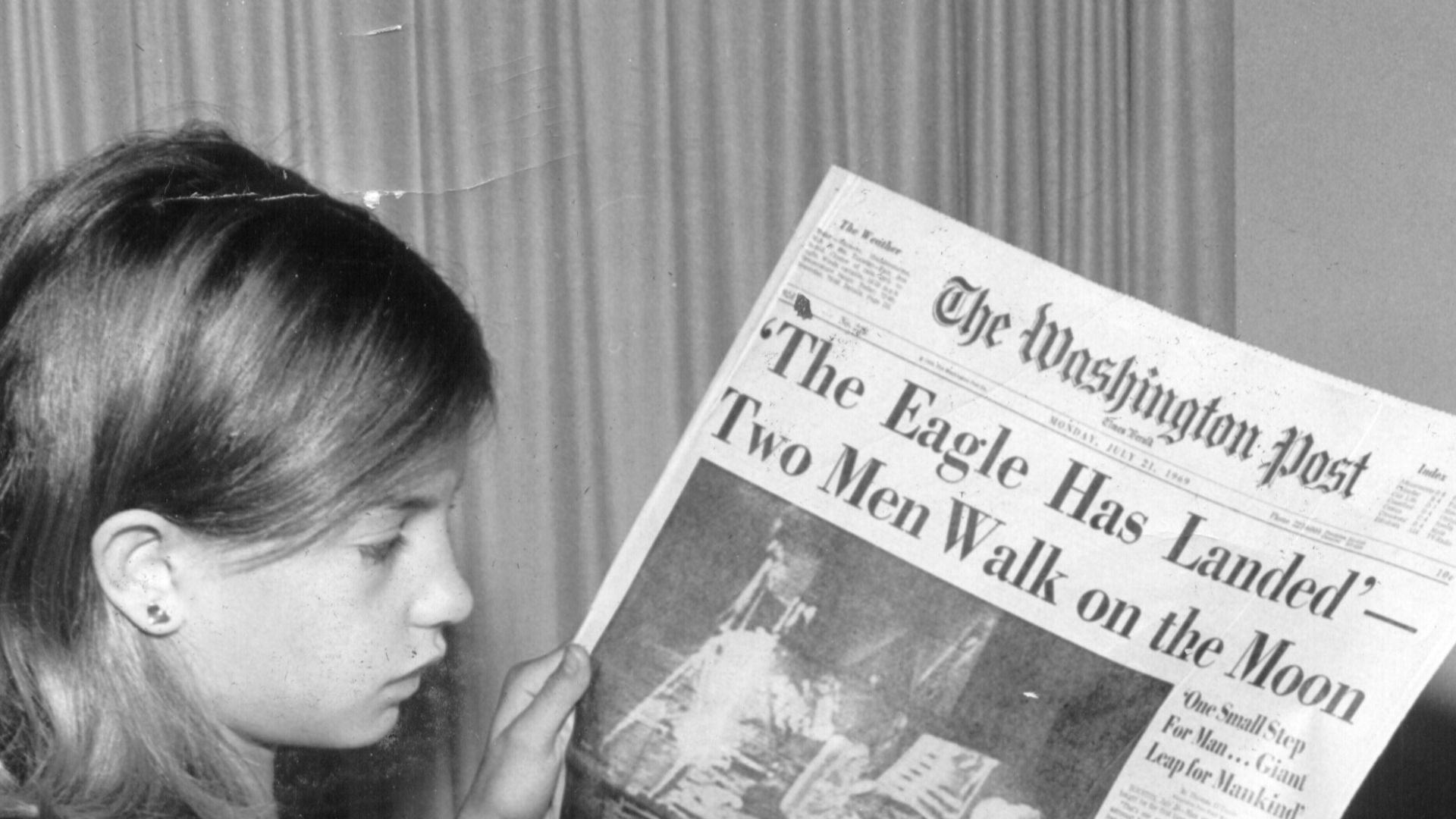 This is a picture of my mother holding the Washington News Paper on Monday, July 21st 1969 stating 'The Eagle Has Landed Two Men Walk on the Moon'. The photo was taken by my grandfather Jack Weir (1928-2005).