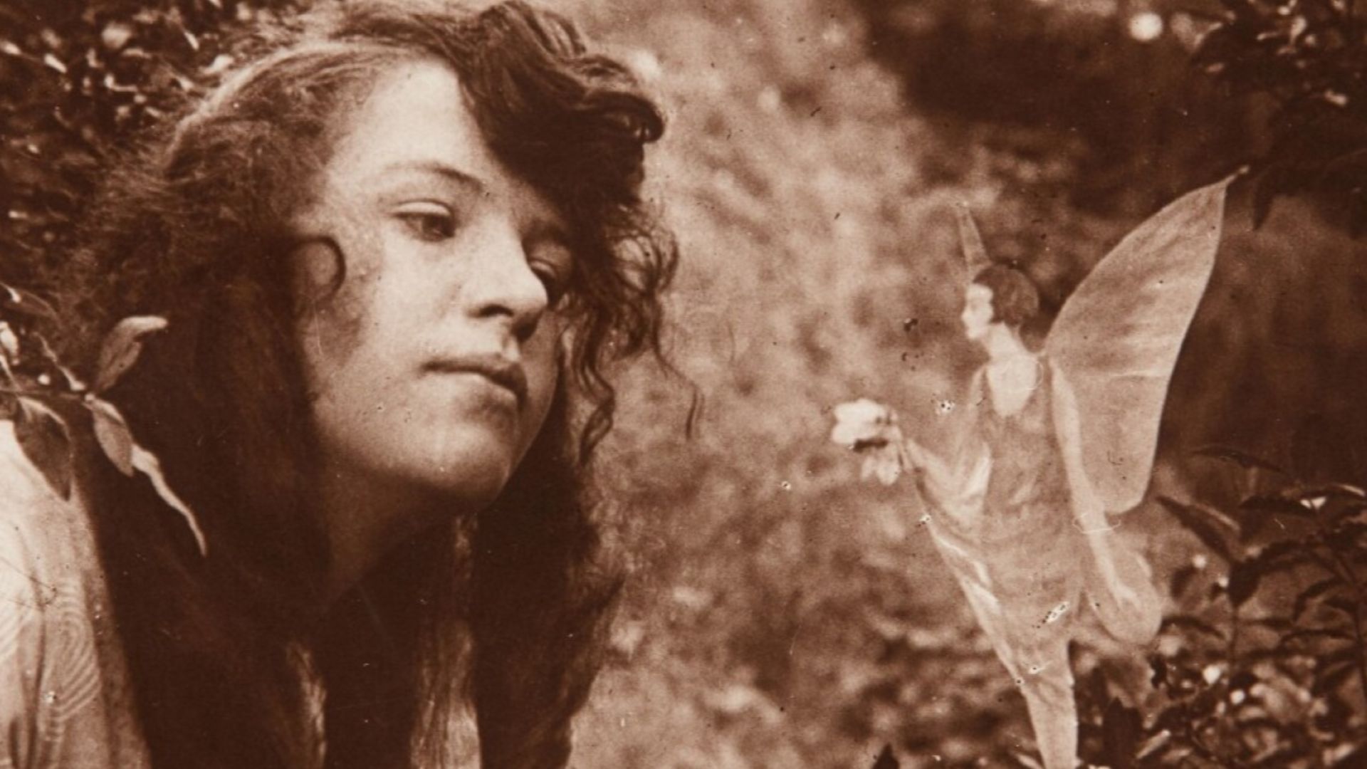 The fourth of the Cottingley Fairies photographs, showing Elsie Wright with a fairy