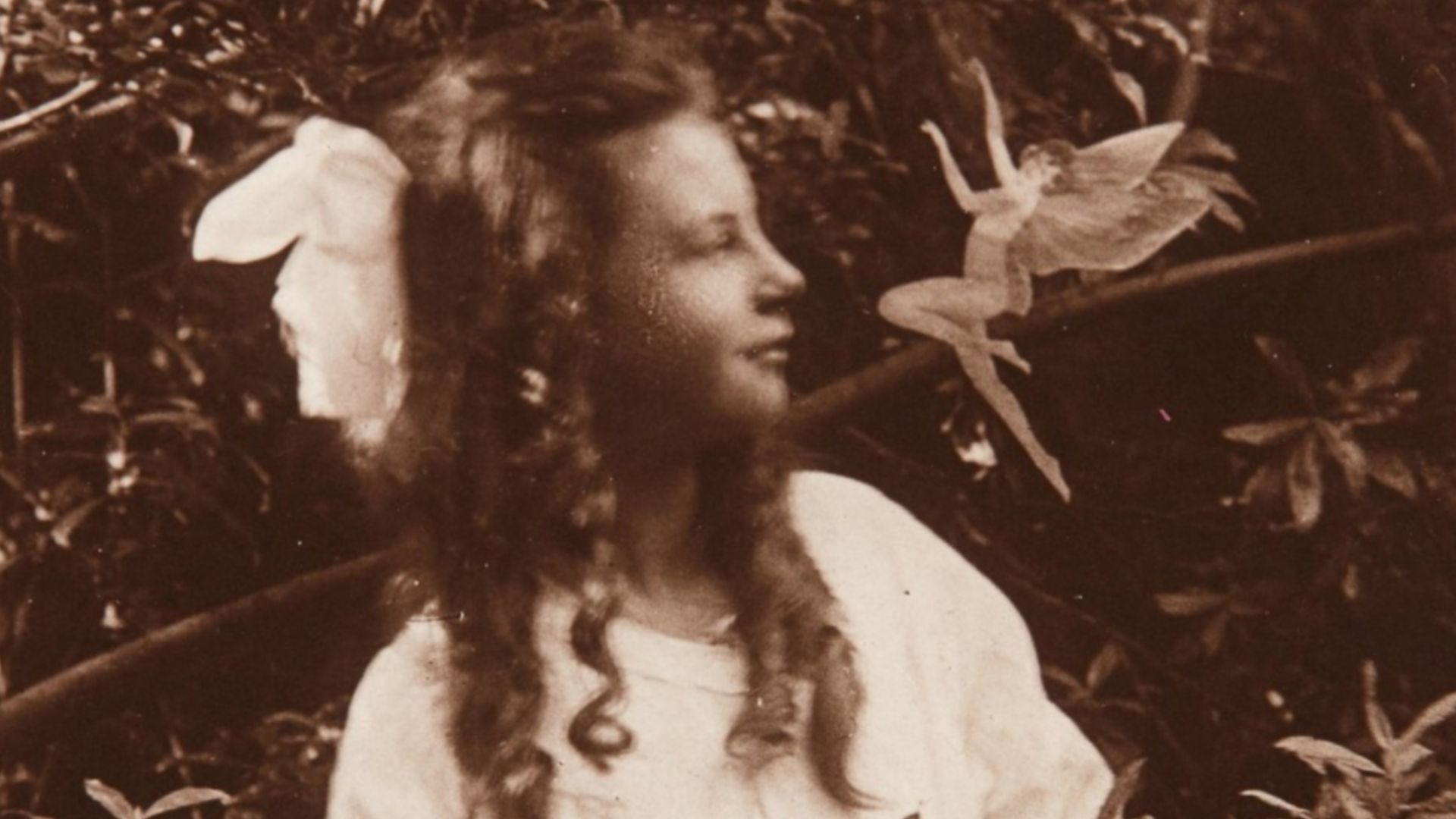 The third of the Cottingley Fairies photographs, showing Frances Griffiths with a fairy