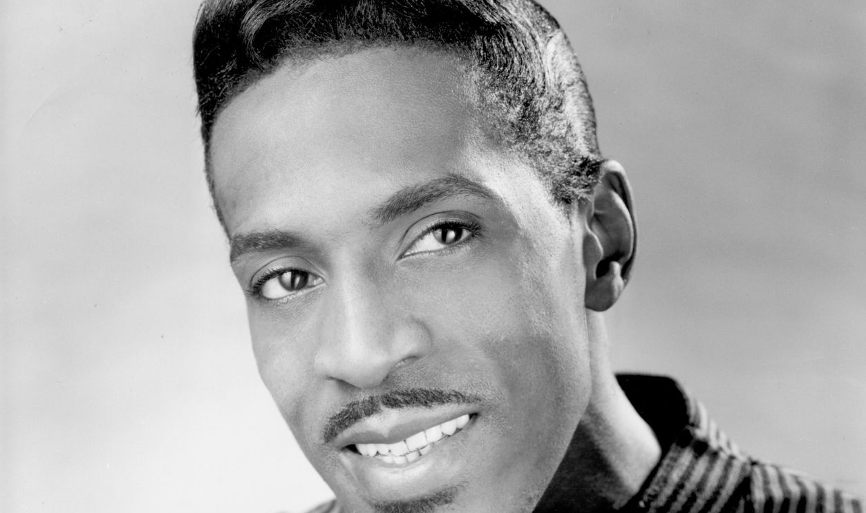 A 1965 promotional portrait of Ike Turner holding an acoustic guitar. 