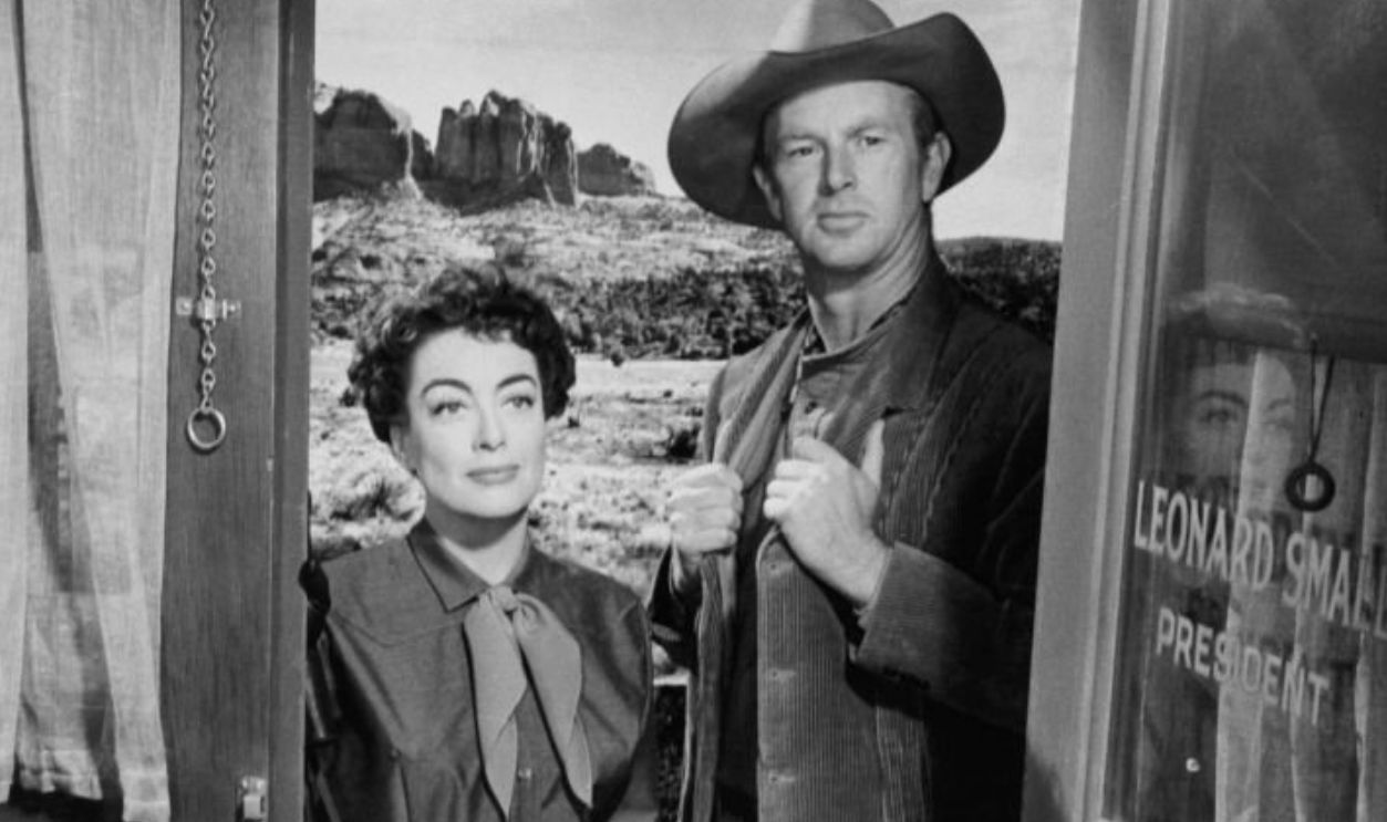 Joan Crawford and Sterling Hayden about to enter office in a scene from the film 'Johnny Guitar', 1954. 
