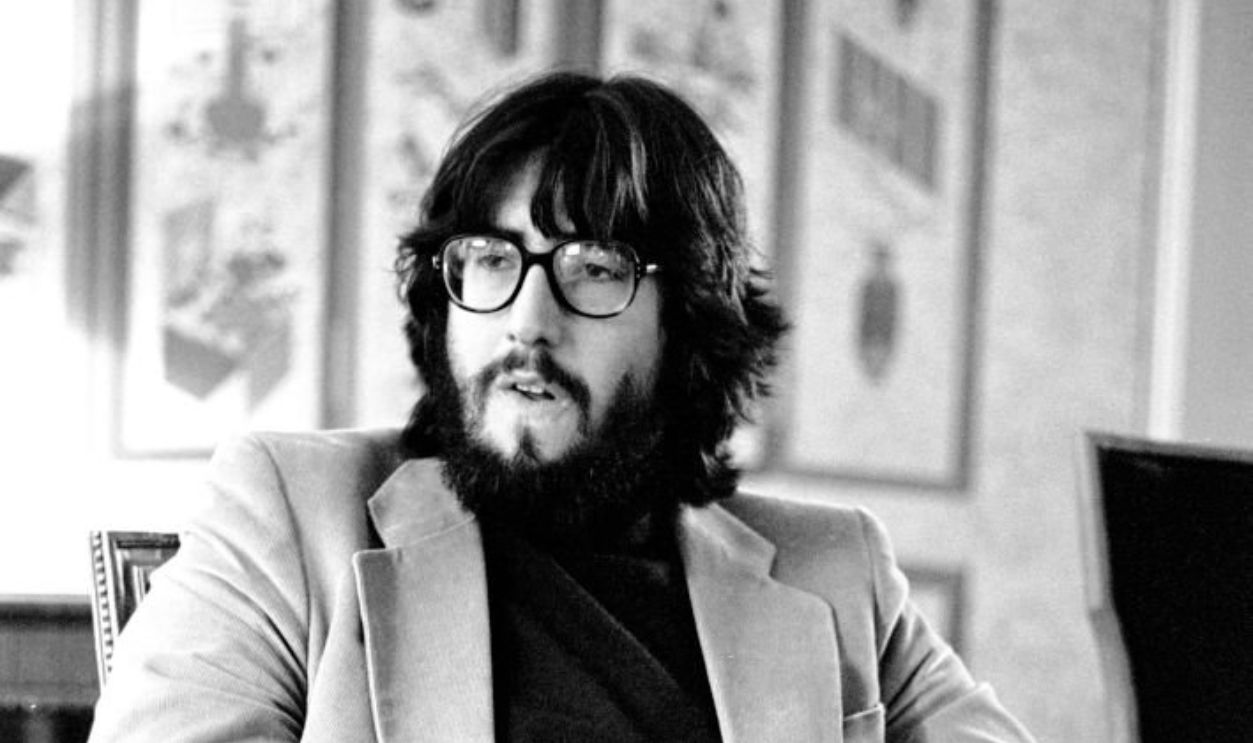 View of film director John Landis as he sits on a chair in the Sherry Netherland Hotel, New York, New York, July 27, 1981. He was there, prior to the premiere of his film 'Animal House' later that evening, for an interview with Oui magazine. 