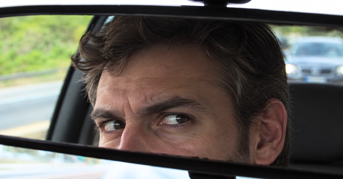 Suspicious Glance in the Rearview Mirror