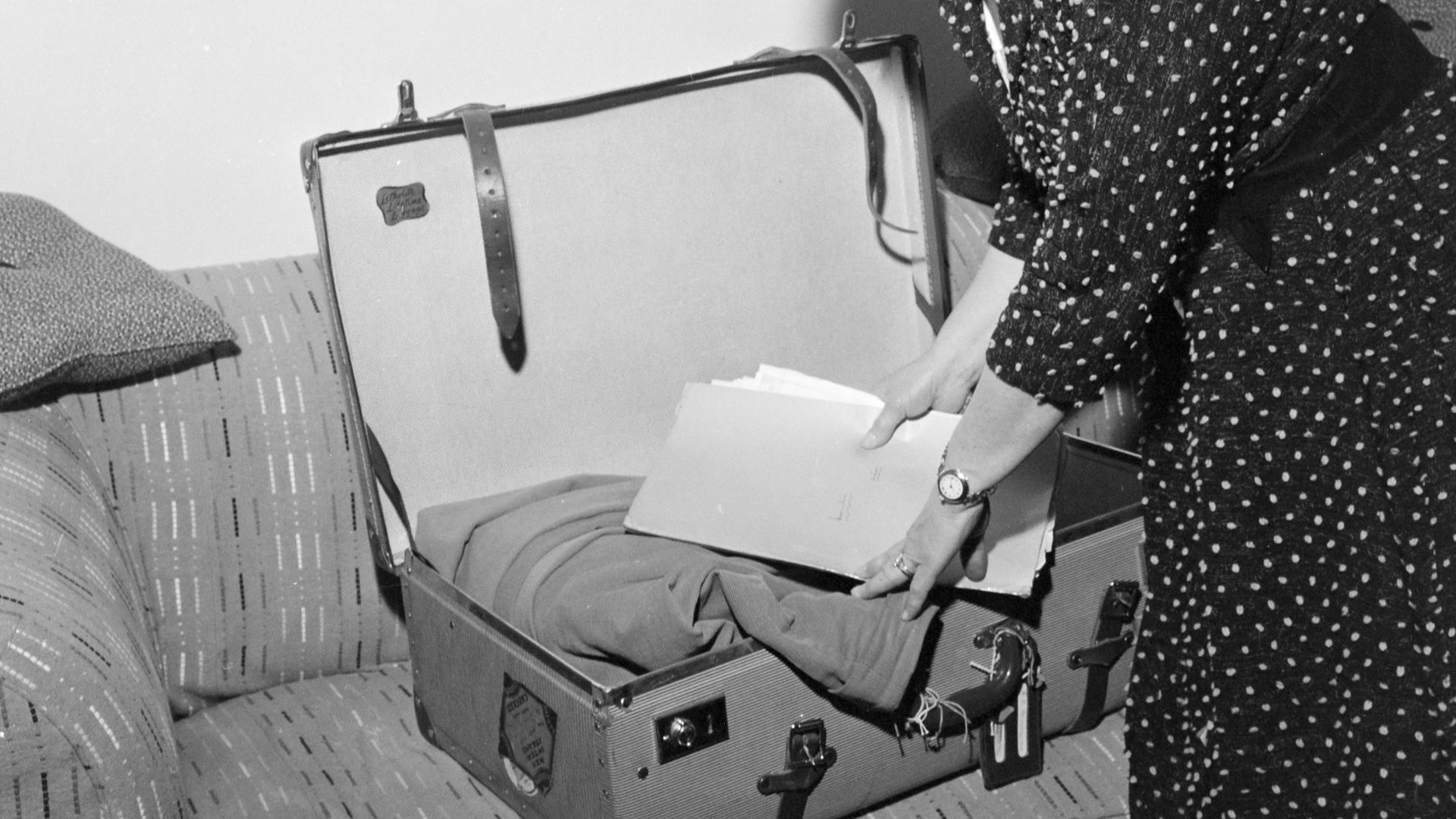 Member of Parliament Mrs Ethel McMillan packing her suitcase, Wellington. Photograph taken for the Evening Post newspaper of Wellington by an unidentified staff photographer.