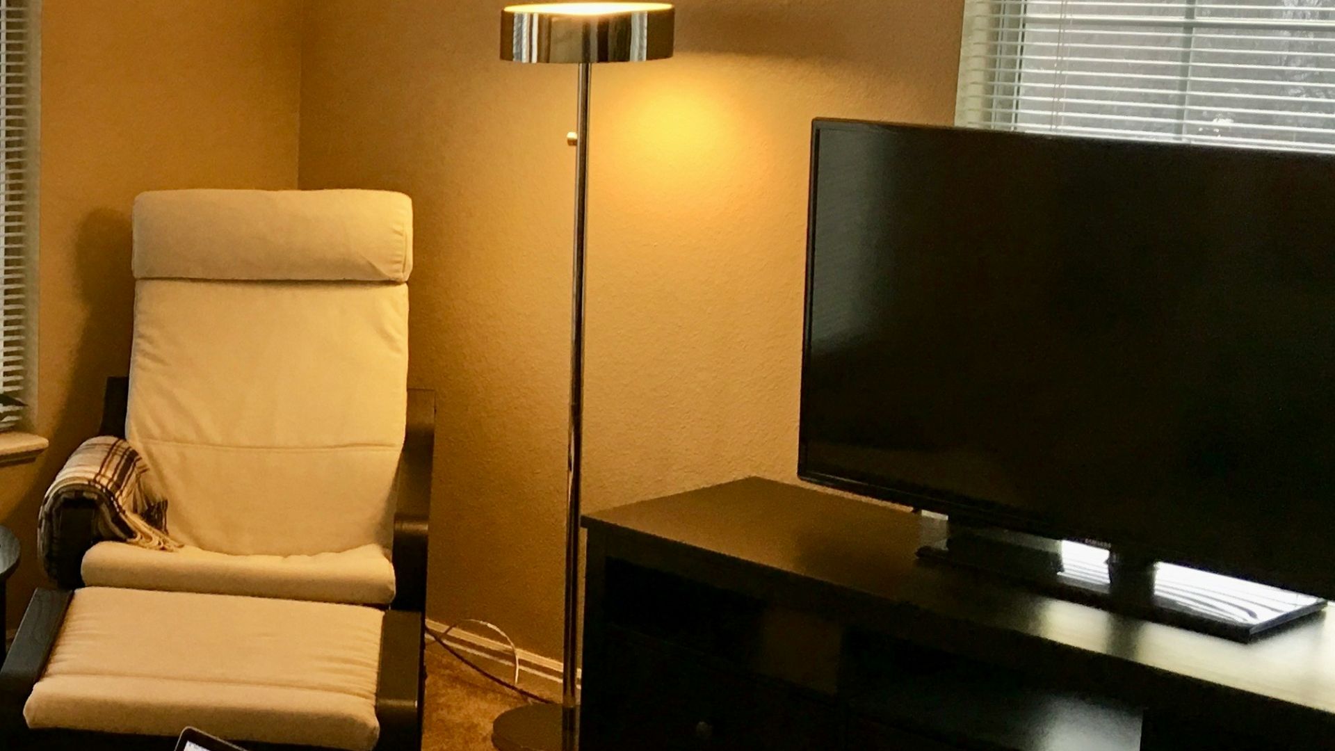 a living room with a laptop on a coffee table
