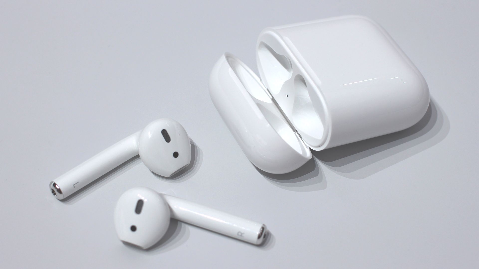 Photo of Apple AirPods wireless headphones and their case.