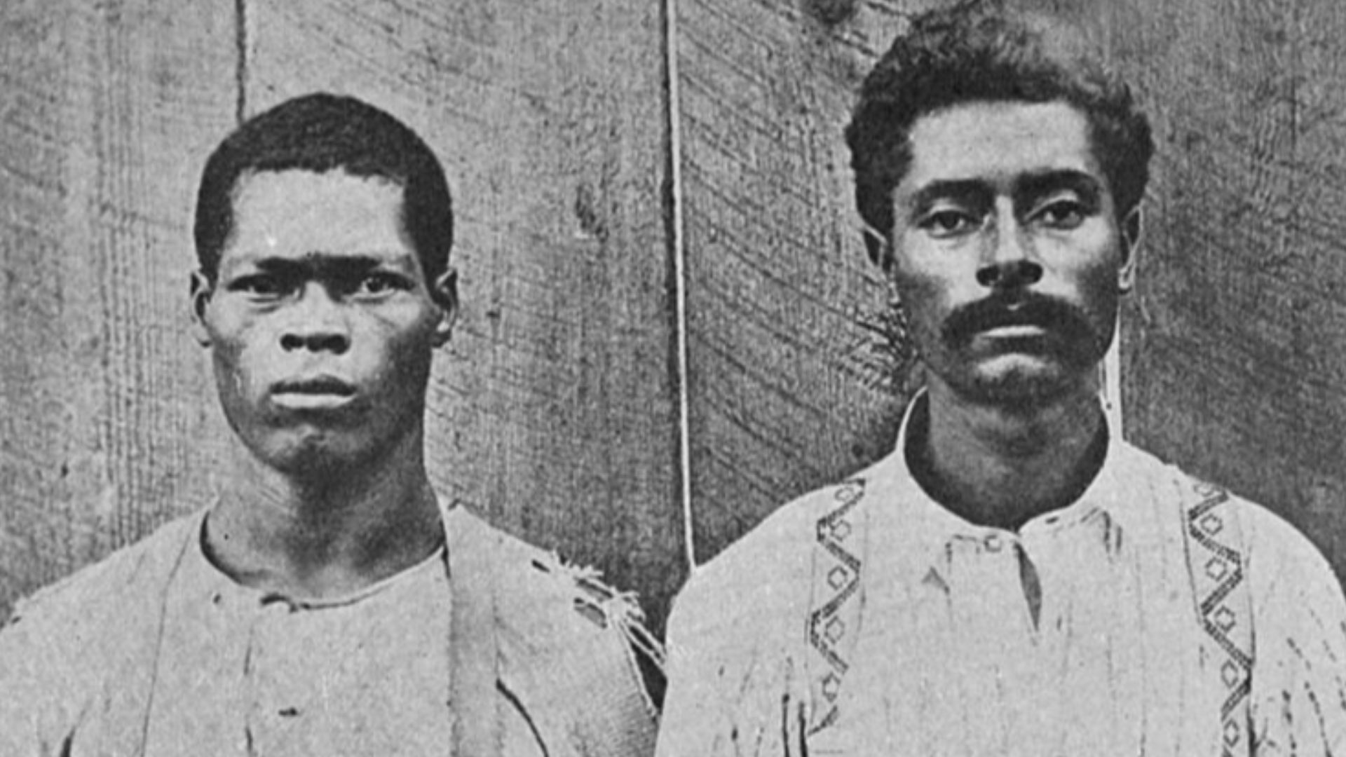 Photo of Paul Reed and Will Cato taken before a mob chained them to a pine stump and burned them to death.