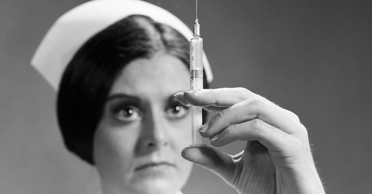 1960s nurse adjusting dosage injection hypodermic needle