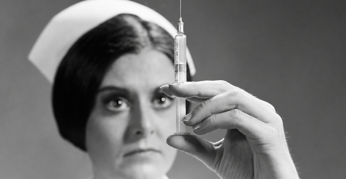 1960s nurse adjusting dosage injection hypodermic needle 