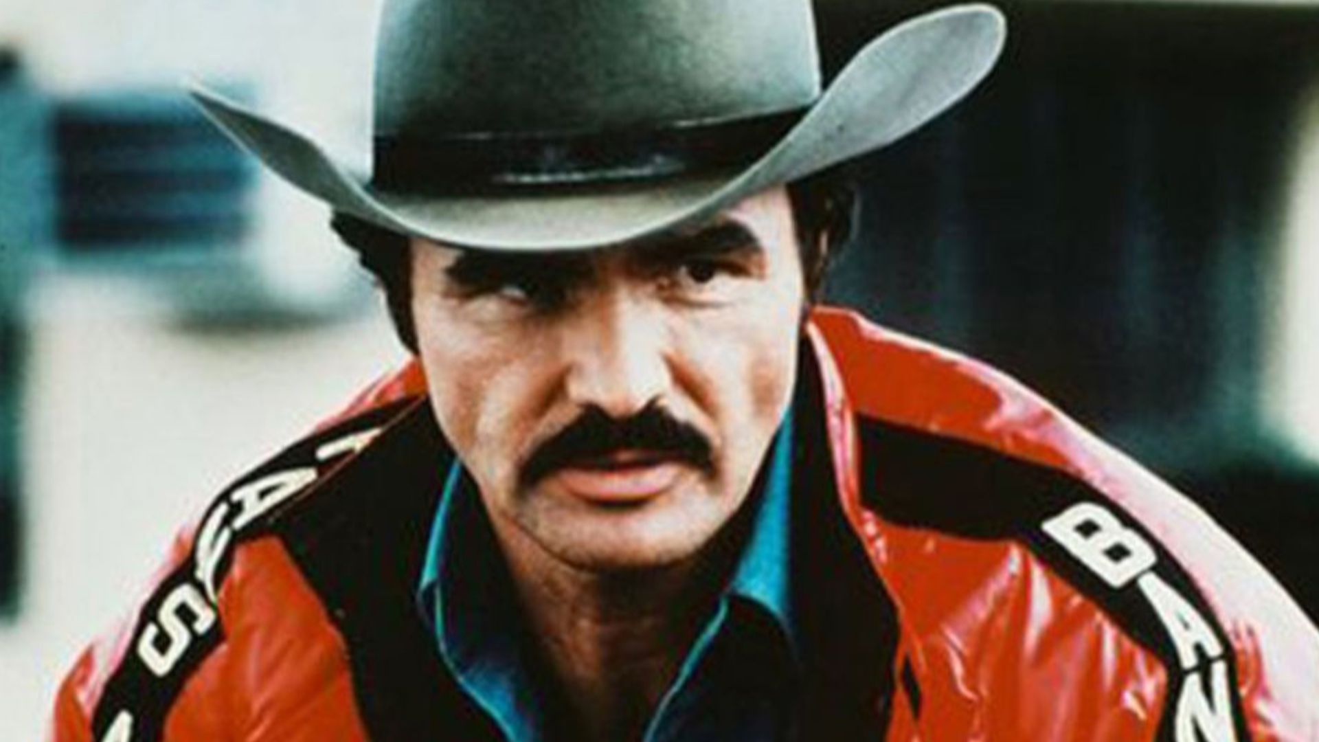 The red Smokey and the Bandit jacket used in the film Smokey and the Bandit 2, starring Burt Reynolds, was designed and manufactured by Jim Watkins in 1977 for Burt Reynolds in Los Angeles, California. watkinssportswear.com is an LA-based company founded 