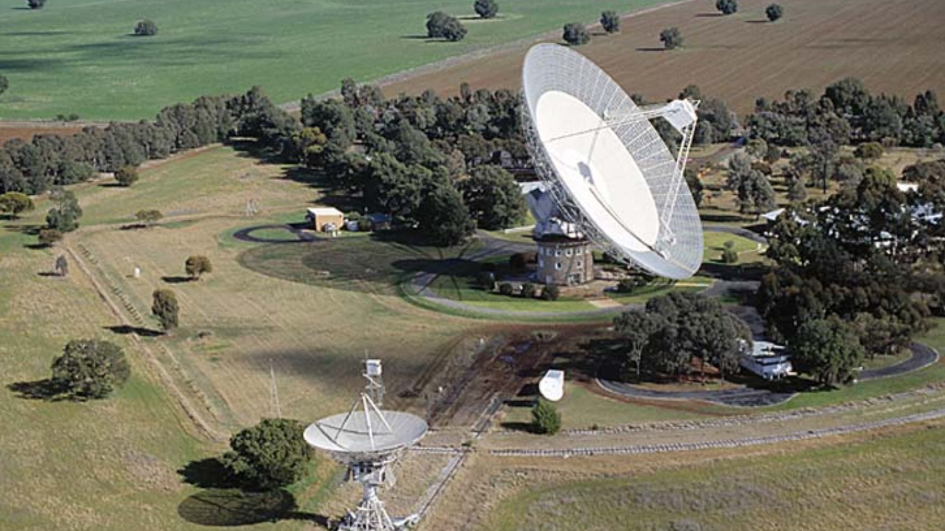 The Parkes radio telescope. The collecting area of the telescope is a 64-m diameter paraboloid (the dish). The surface is high precision aluminium millimetre wavepanels to a diameter of 17-m (for operation to 43 GHz), then perforated aluminium plate out t