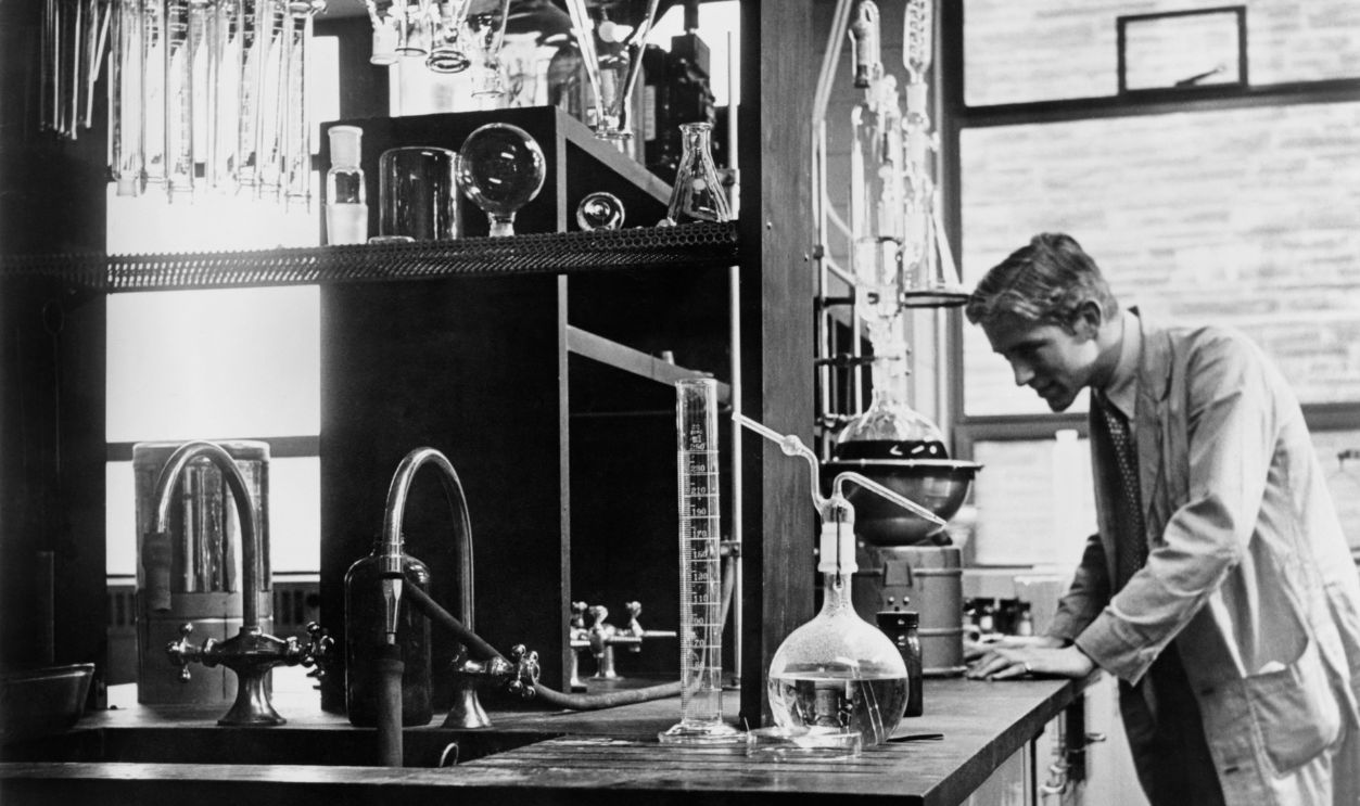 Scientist conducting a laboratory experiment in a cancer research facility in the United States, 1951.