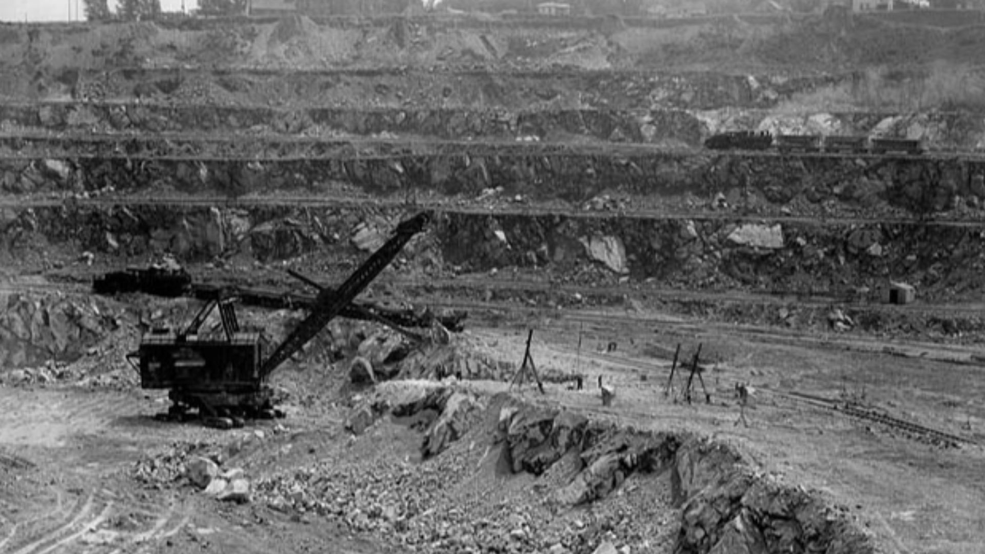 Canada's biggest power shovel loading an ore train with asbestos at the Jeffrey Mine, Johns-Manville Co., Asbestos, Quebec, June 1944.