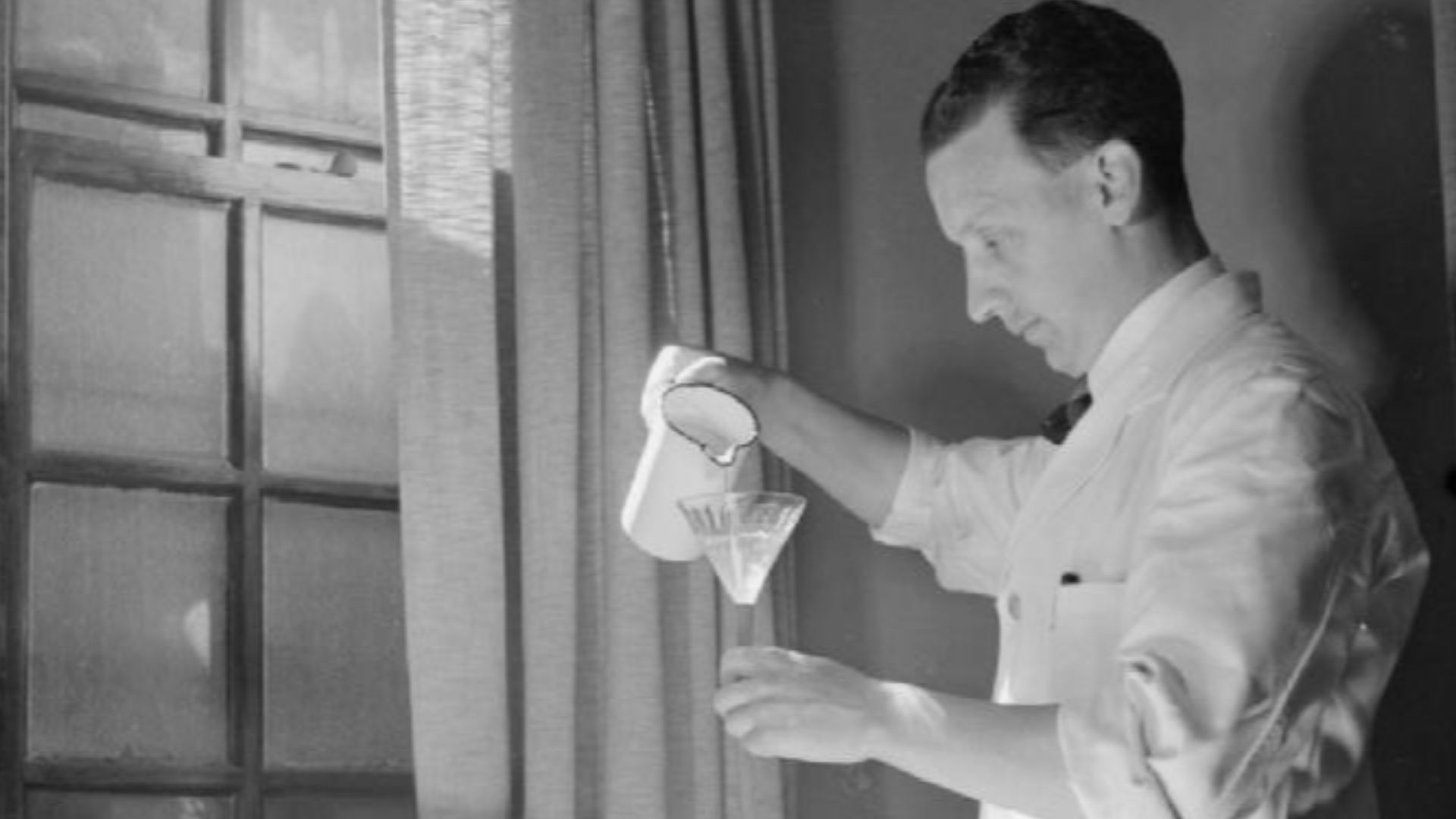 Male Nurses- Life at Runwell Hospital, Wickford, Essex, 1943
A male nurse gives glucose to a patient undergoing Insulin Shock Therapy at Runwell Hospital.  The glucose is being poured from a jug into a funnel and down a tube which goes into the patient's 