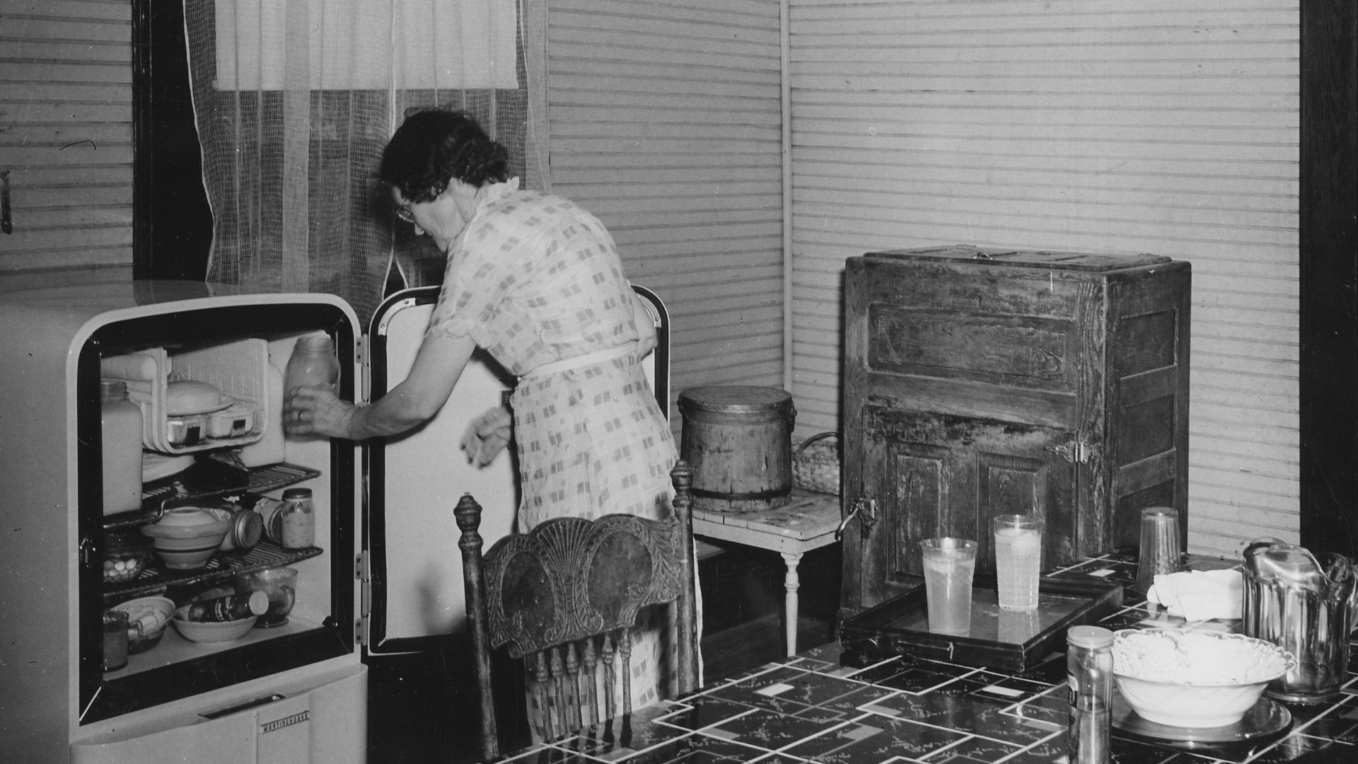 Scope and content:  Full caption reads as follows: Harmony Community, Putnam County, Georgia. This housewife is enthusiastic about REA, and with good reason. Her home has just been electrified. See the two ice-boxes in this kitchen - the old vs. the new.