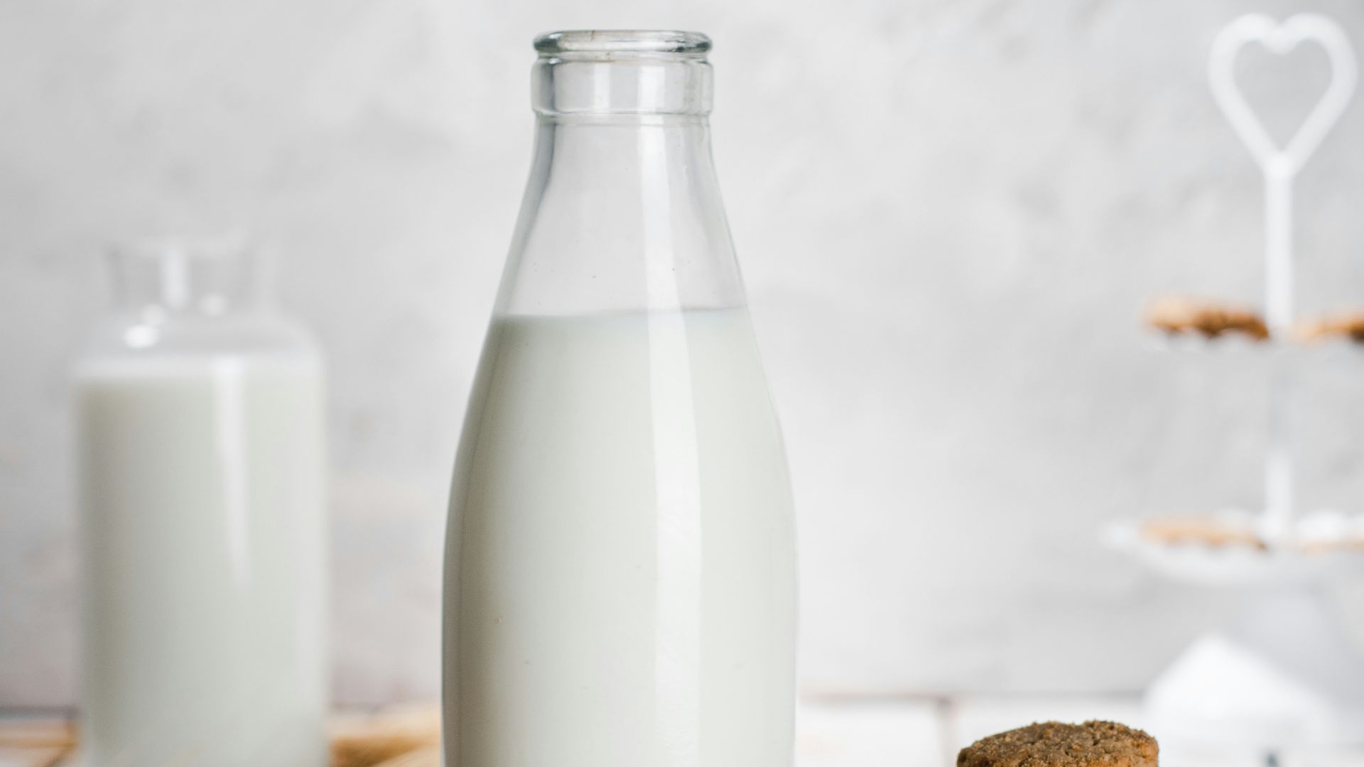 a bottle of milk and some cookies on a table