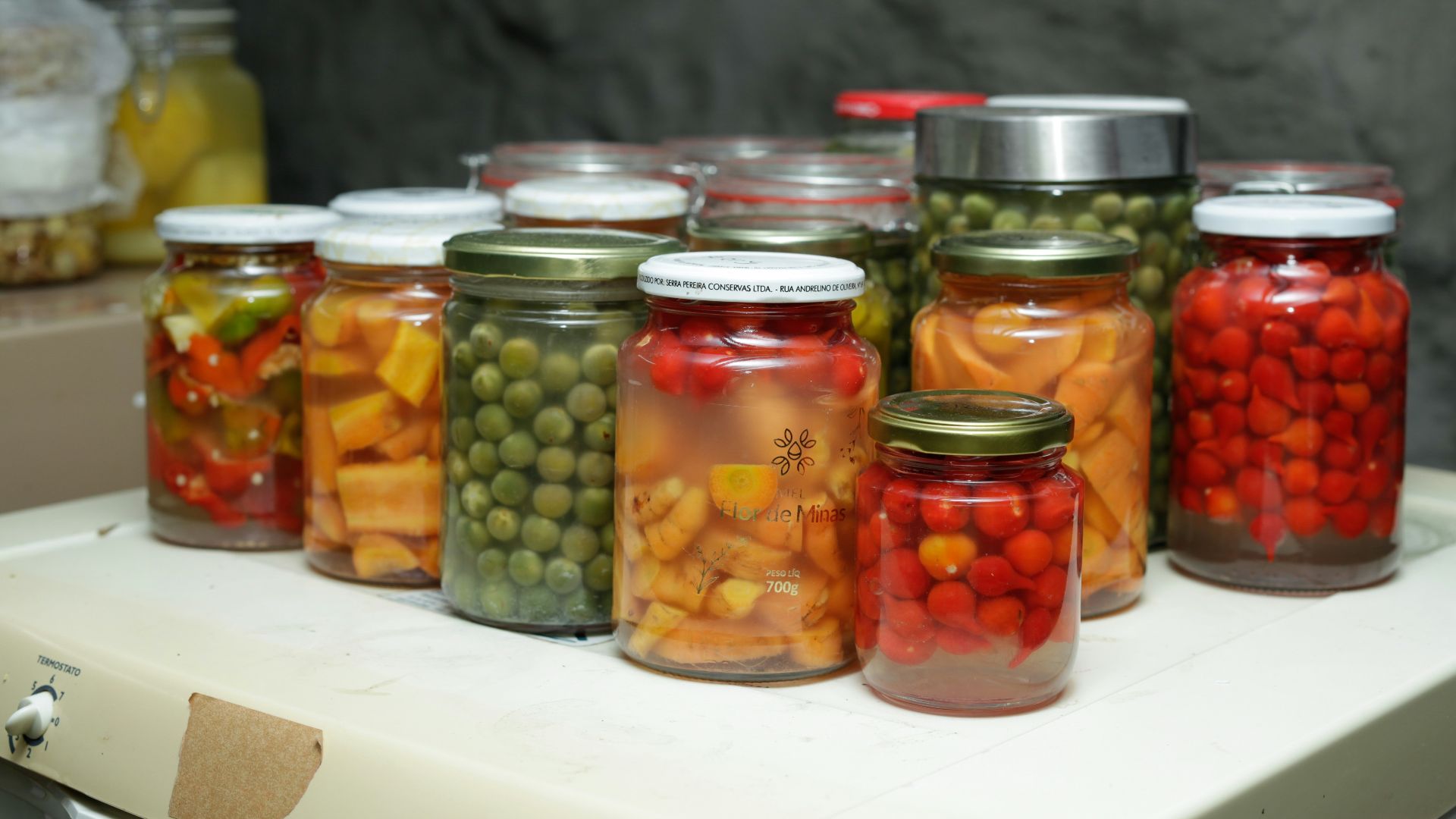 Jars of preserved vegetables and fruits on a shelf