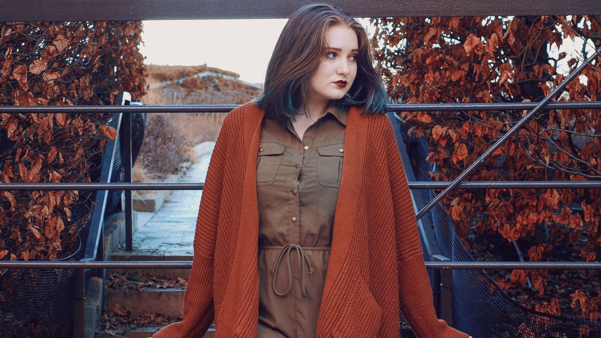 woman wearing brown button-up dress and orange open long-sleeved cardigan during daytime