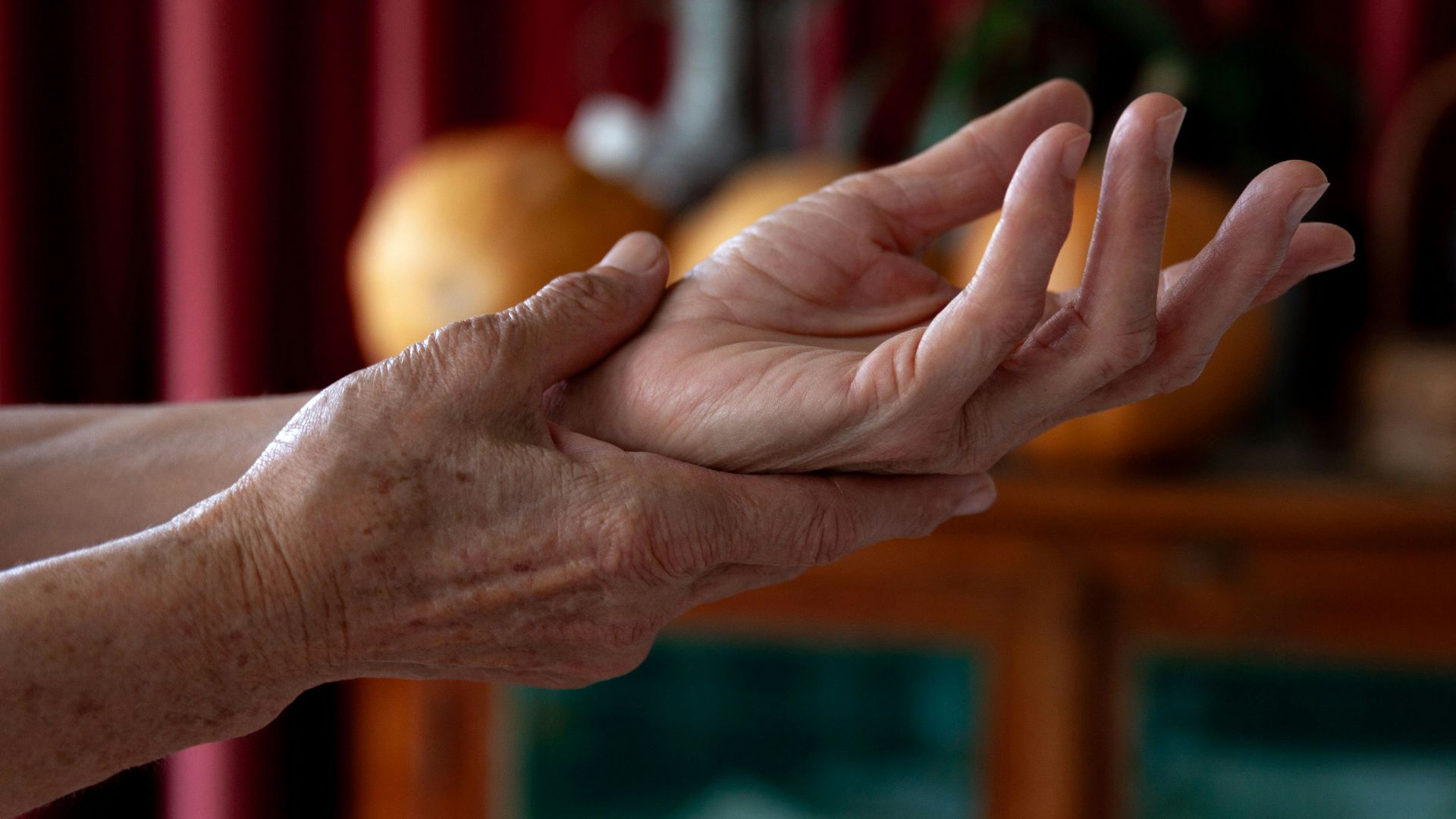 A woman holding out her hands in a living room
