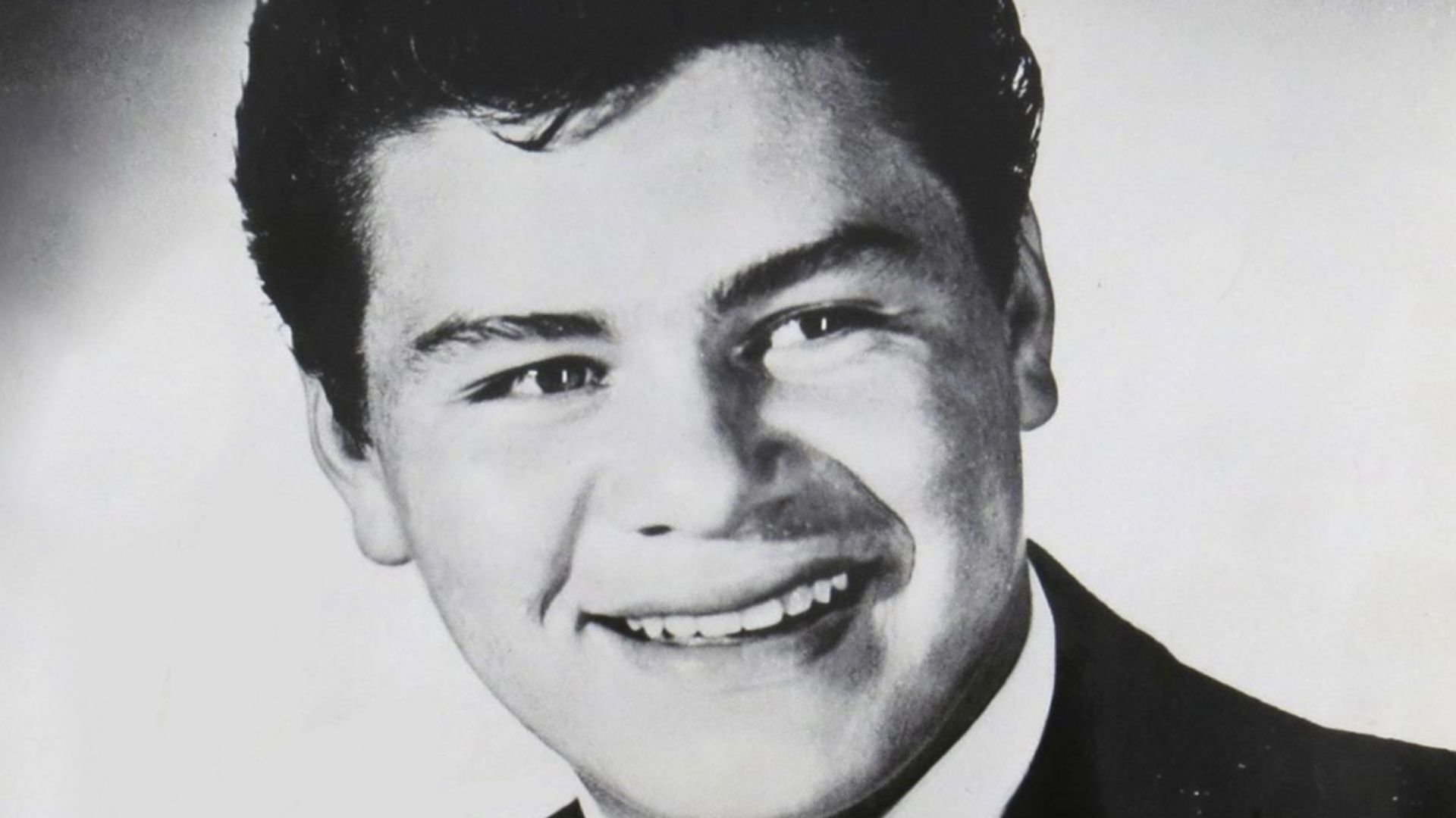 Ritchie Valens in a press photo dated to 1959. No copyright markings on the photo. The signature reads,