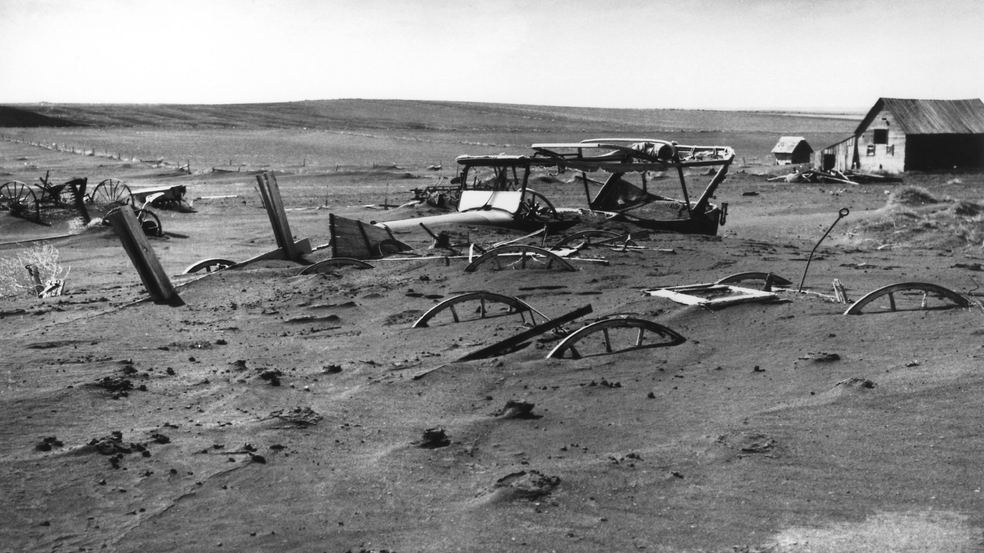 Buried machinery in barn lot in Dallas, South Dakota, United States during the Dust Bowl, an agricultural, ecological, and economic disaster in the Great Plains region of North America in 1936