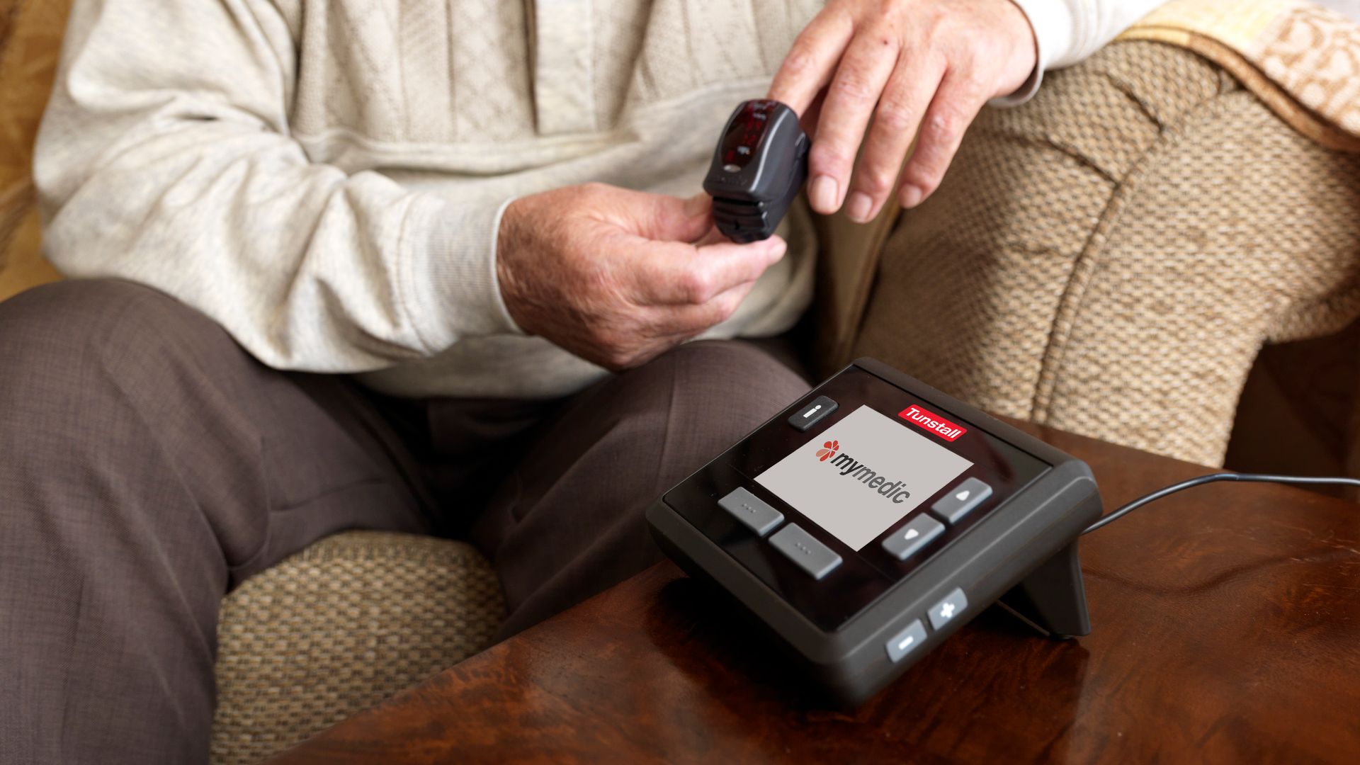 An elderly man using a pulse oximeter.