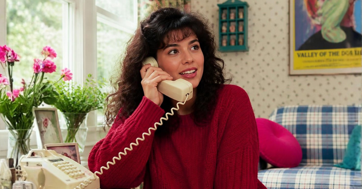 90s woman talking on house phone