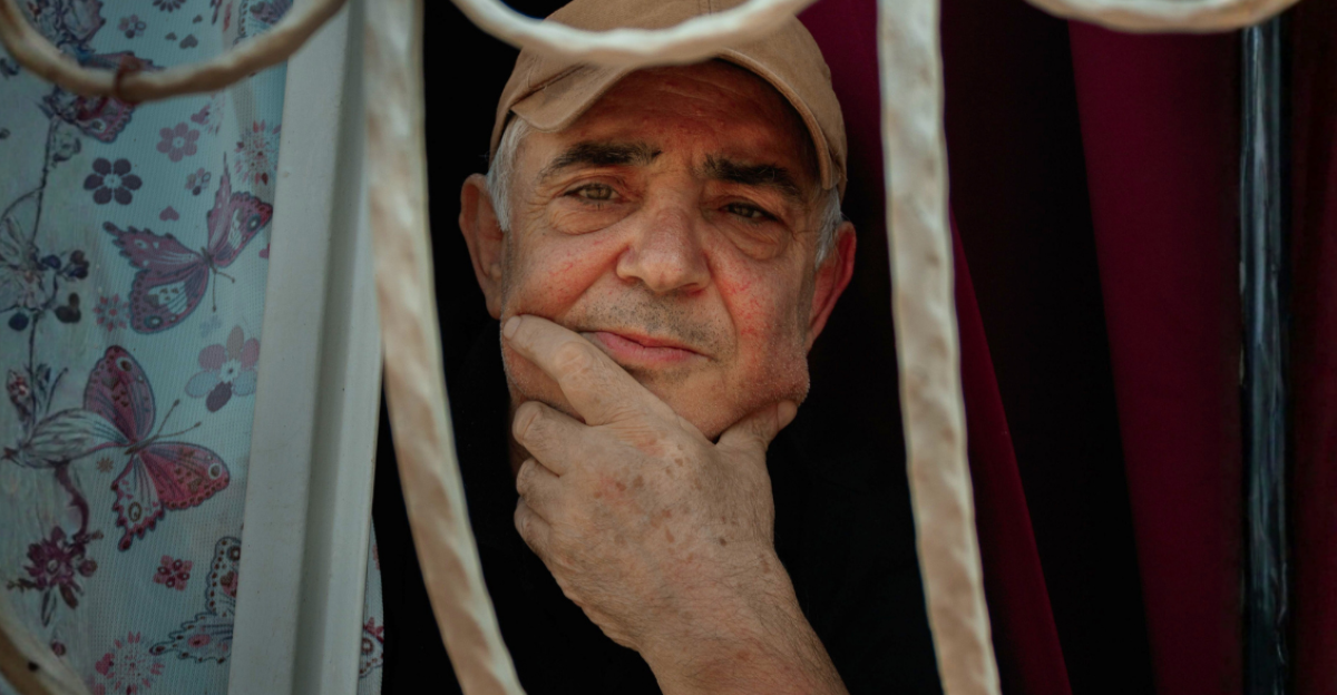 pensive-elderly-man-gazing-through-window-bars