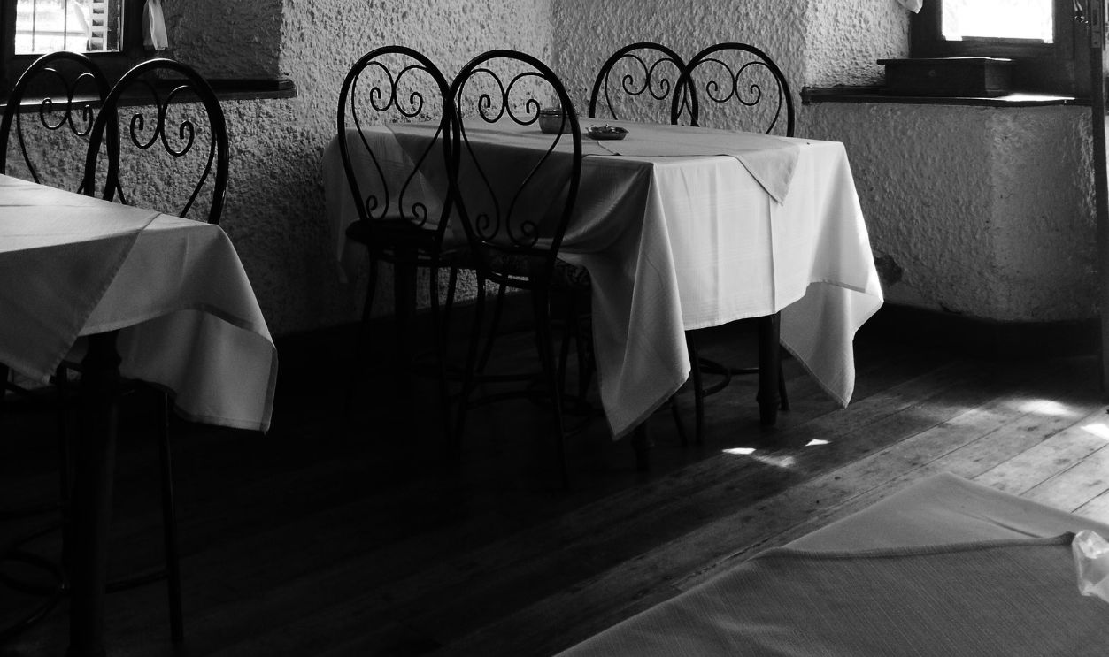 Black and white interior view of an empty restaurant with classic decor in Madagascar