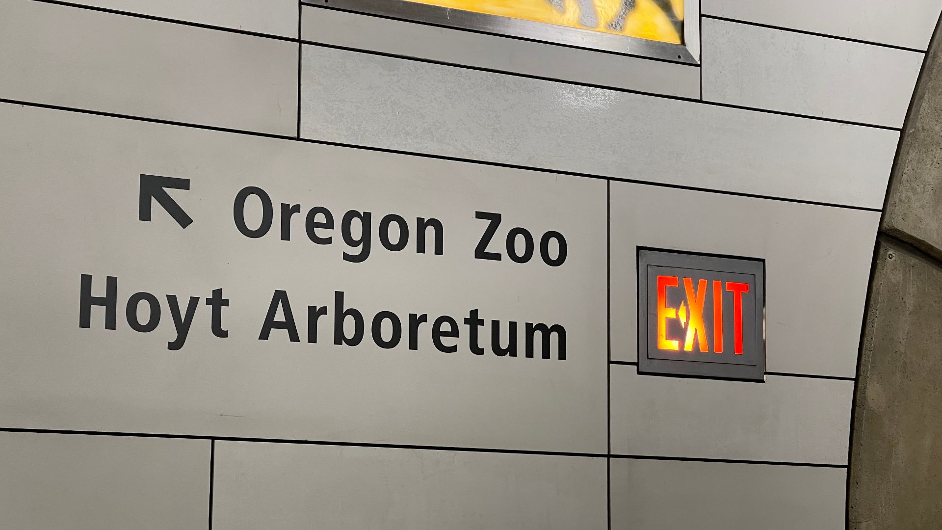 An exit sign at the Washington Park station on TriMet's MAX Light Rail. Interestingly, the arrow on the illuminated exit sign is placed within the word