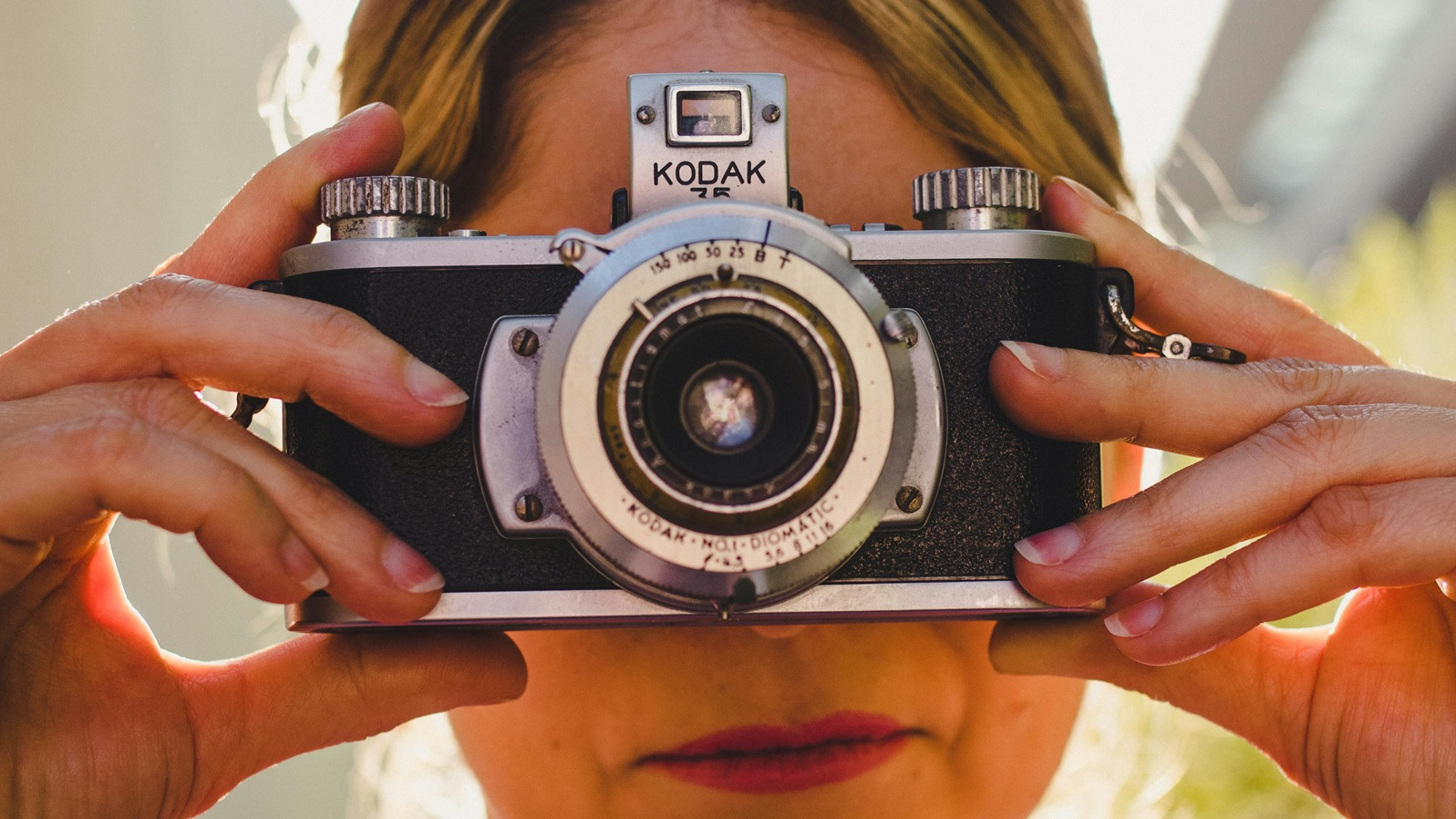 A Woman Using a Vintage Kodak Camera
