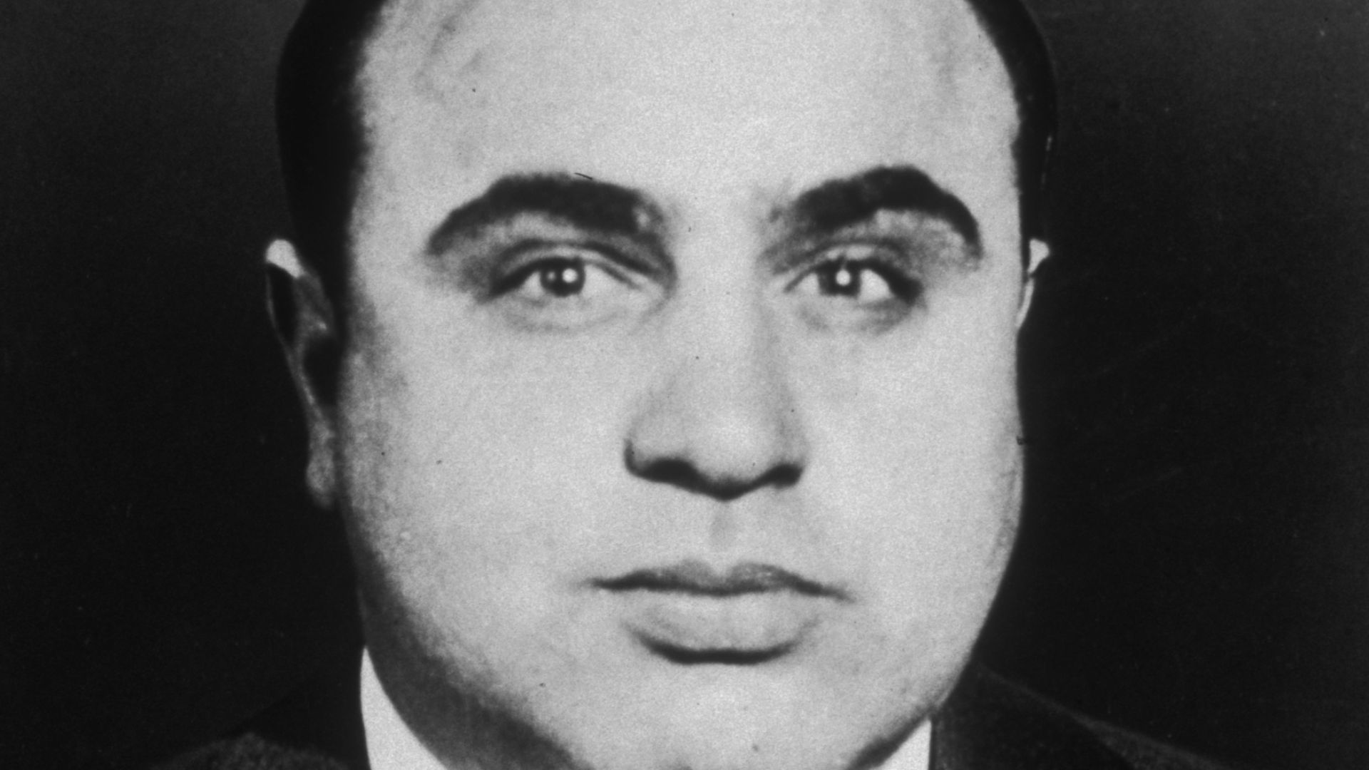 Al Capone sitting.