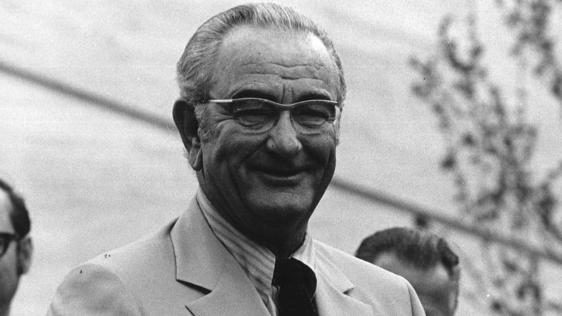 Black and white photograph print of Lyndon B. Johnson at the dedication of a library in his honor.