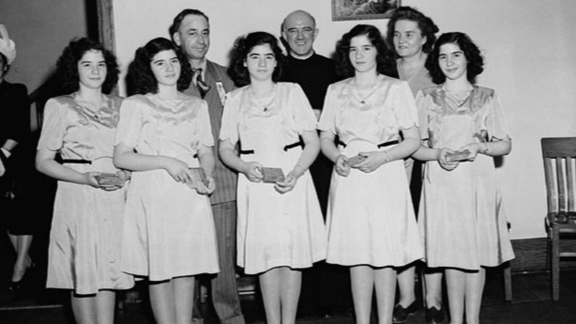 The Dionne quintuplets, accompanied by Mr Oliva Dionne and Frère Gustave Sauvé, take part in a program of religious music at Lansdowne Park, during the five day Marian Congress which prayed for peace and celebrated the centenary of the Ottawa archdiocese