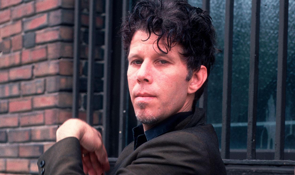 Portrait of American Blues, Rock, and Jazz musician Tom Waits as he poses outside the Briar Street Theater, Chicago, Illinois, May 30, 1986. 